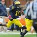 Michigan senior quarterback Denard Robinson runs the ball for yards minus a shoe during the second quarter at Michigan Stadium on Saturday.  Melanie Maxwell I AnnArbor.com